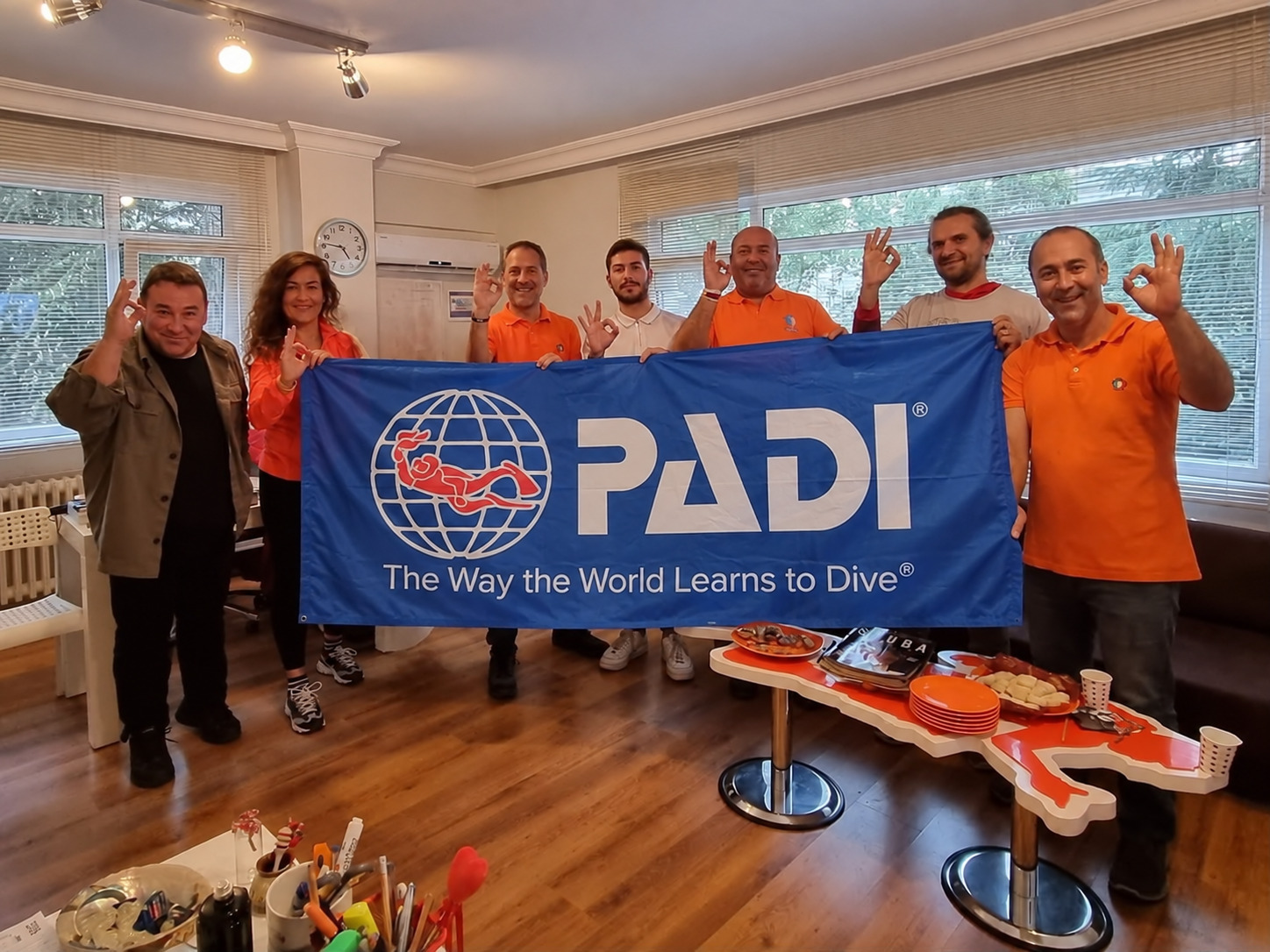 Deepist team at the Istanbul office with a PADI flag